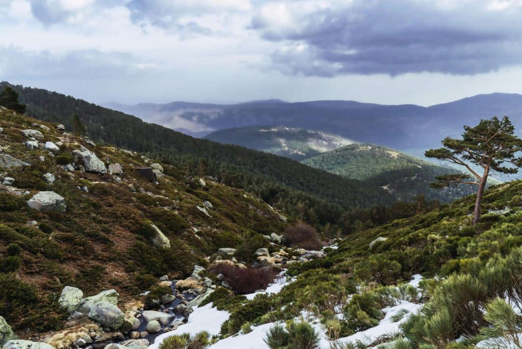 Hermosa vista invernal de las montañas de Segovia con nieve, bosques y nubes espectaculares.